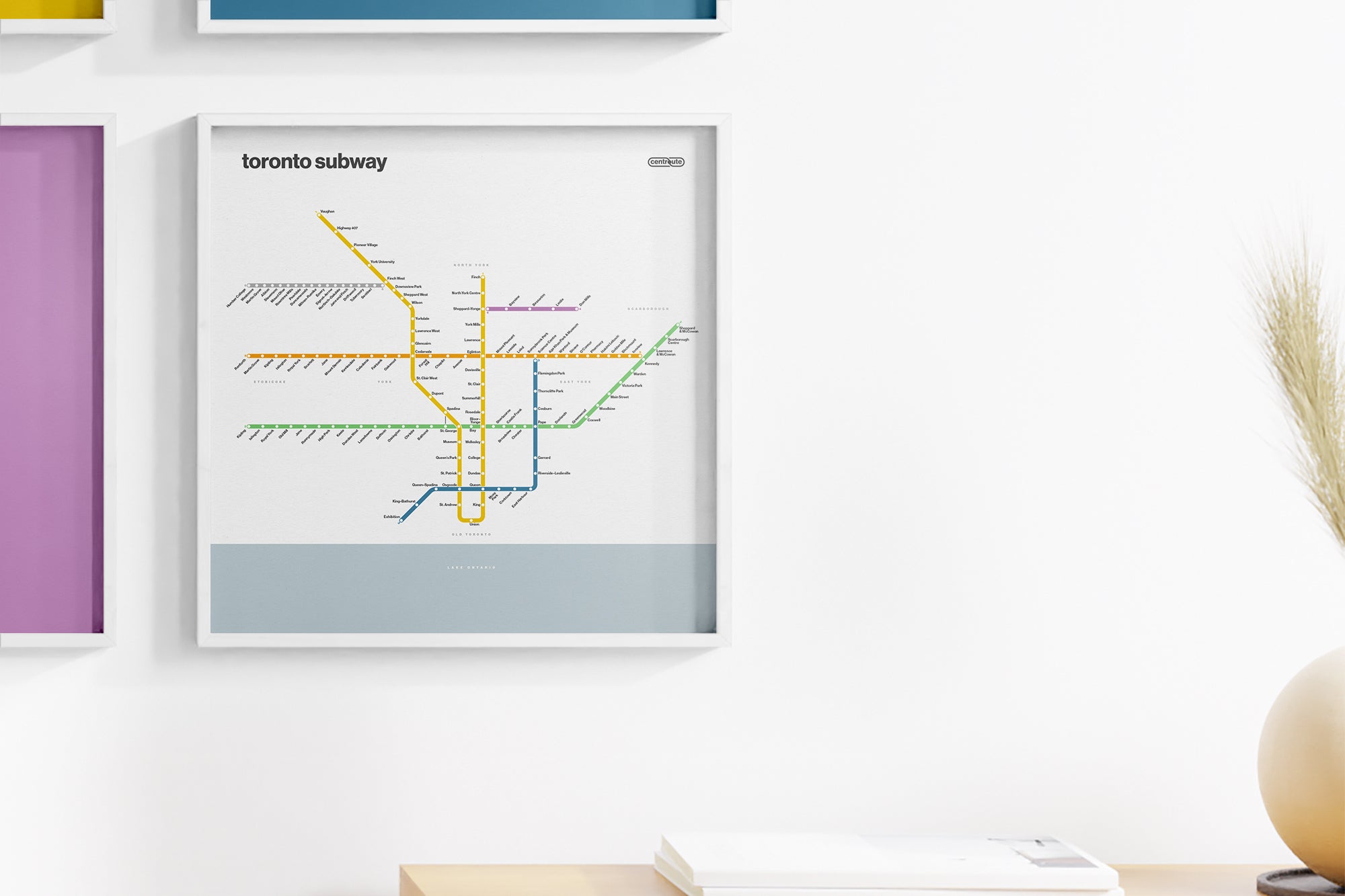 a framed subway map of Toronto, Canada, hanging on a wall.