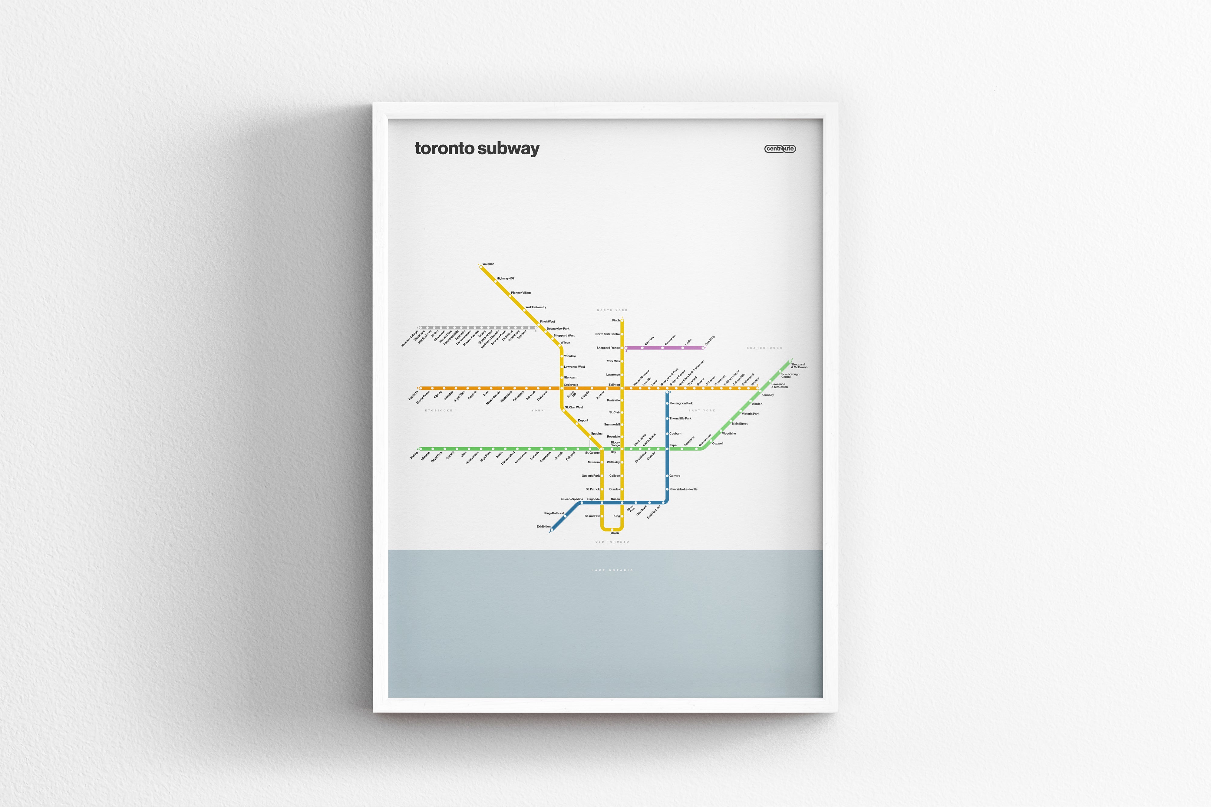 A framed subway map of Toronto, Canada, with various colored lines representing different routes and stations.