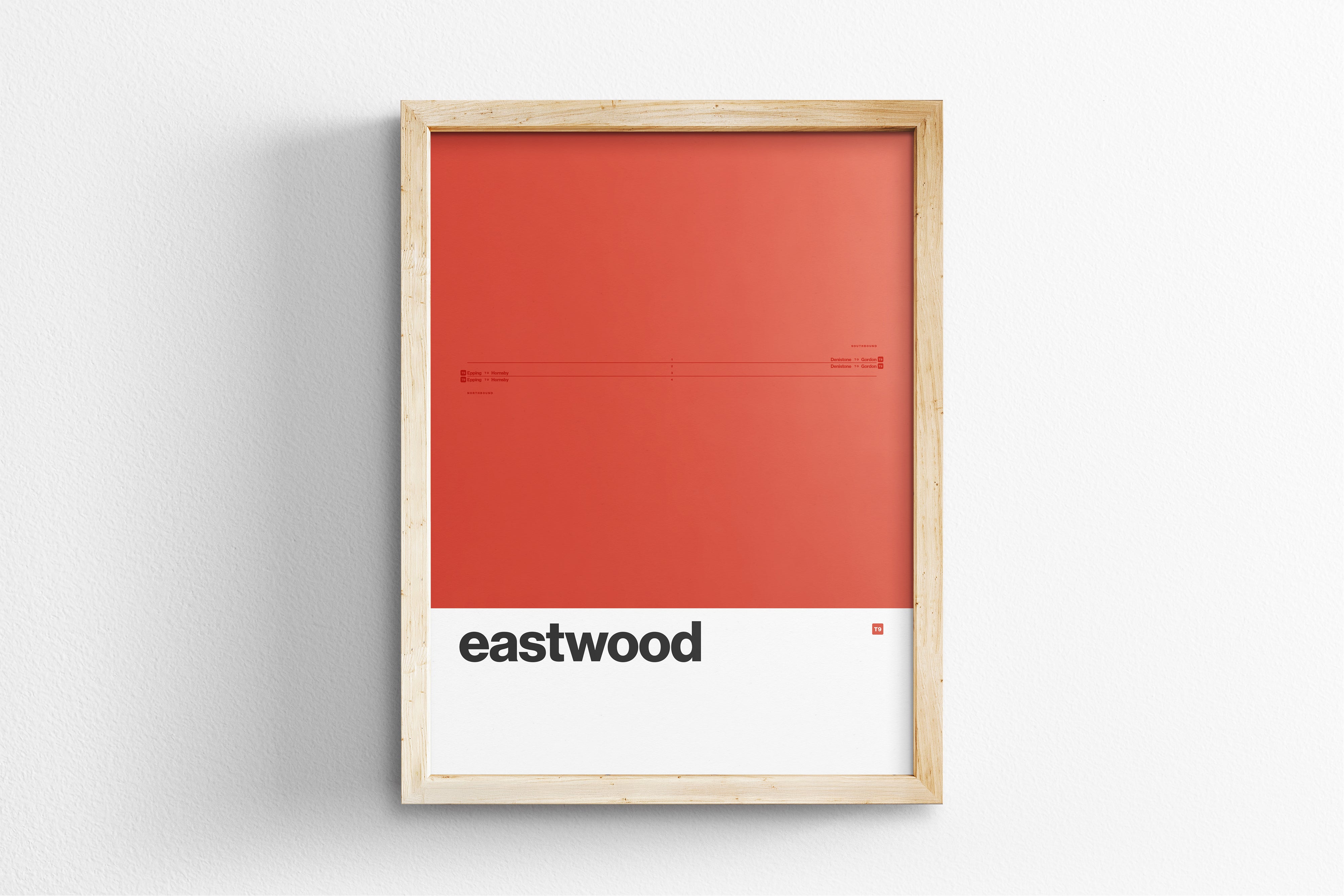 The image is a framed poster with a red background and the word "eastwood" written in black text.