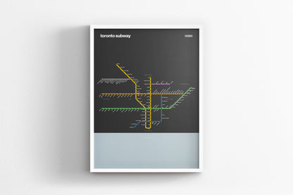 A framed subway map of Toronto, Canada, with various colored lines representing different routes and stations.