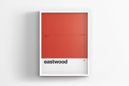 A framed poster with a red background and the word "eastwood" written in black text.
