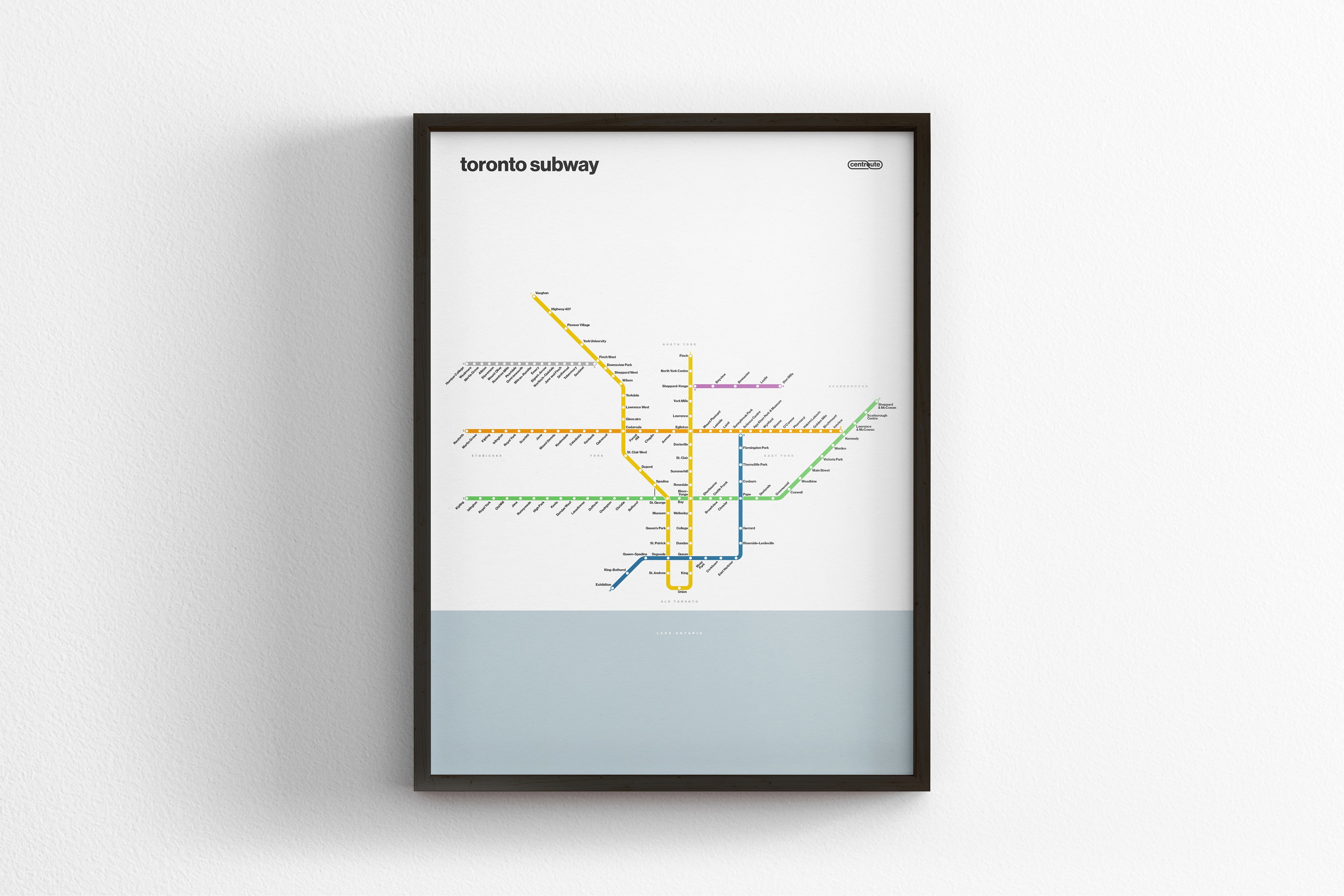 A framed subway map of Toronto, Canada, depicting the underground transit system with various lines and stations labeled.