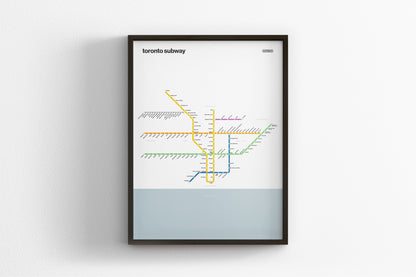 A framed subway map of Toronto, Canada, depicting the underground transit system with various lines and stations labeled.