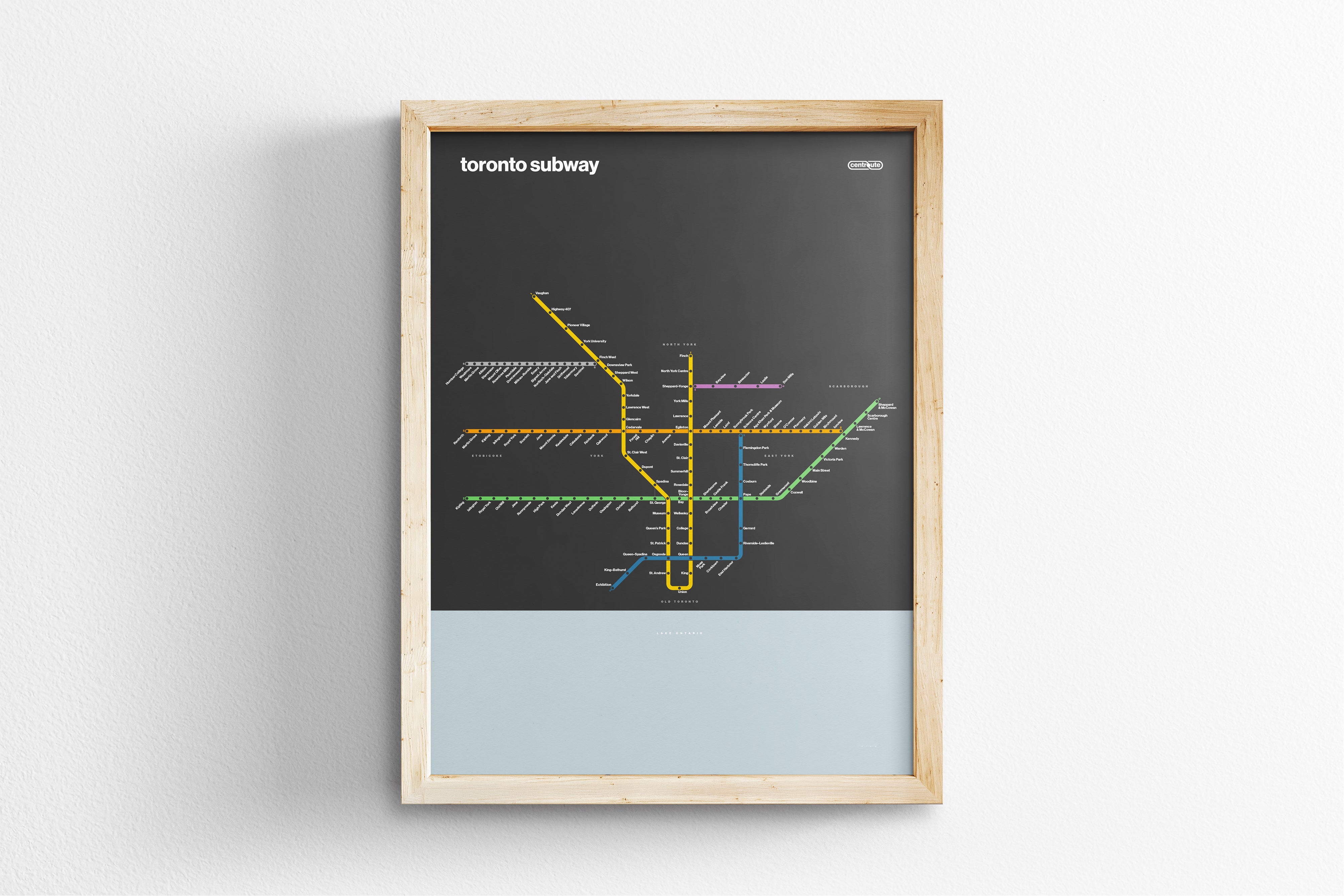 A framed subway map of Toronto, Canada, with various colored lines representing different routes and stations.